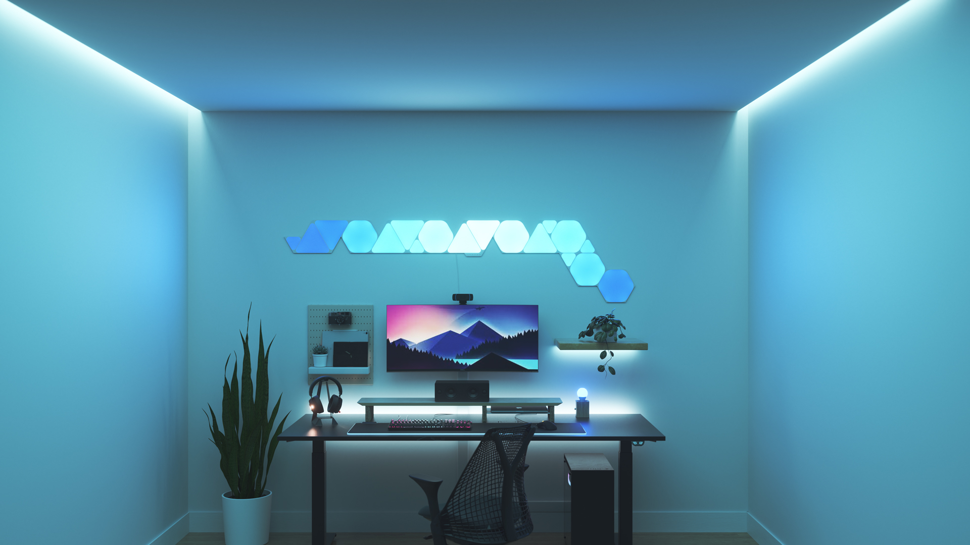 Un espace de jeu au style minimaliste avec les panneaux lumineux Nanoleaf Shapes RGB intelligents au-dessus de votre moniteur. Les jeux sur ordinateur sont meilleurs avec ces jeux de lumière.